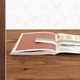 Image for article titled An Elegantly Low-Tech Cookbook Holder Powered By Gravity